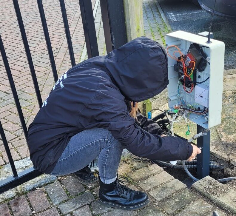 an expert gate engineer fixing a control panel